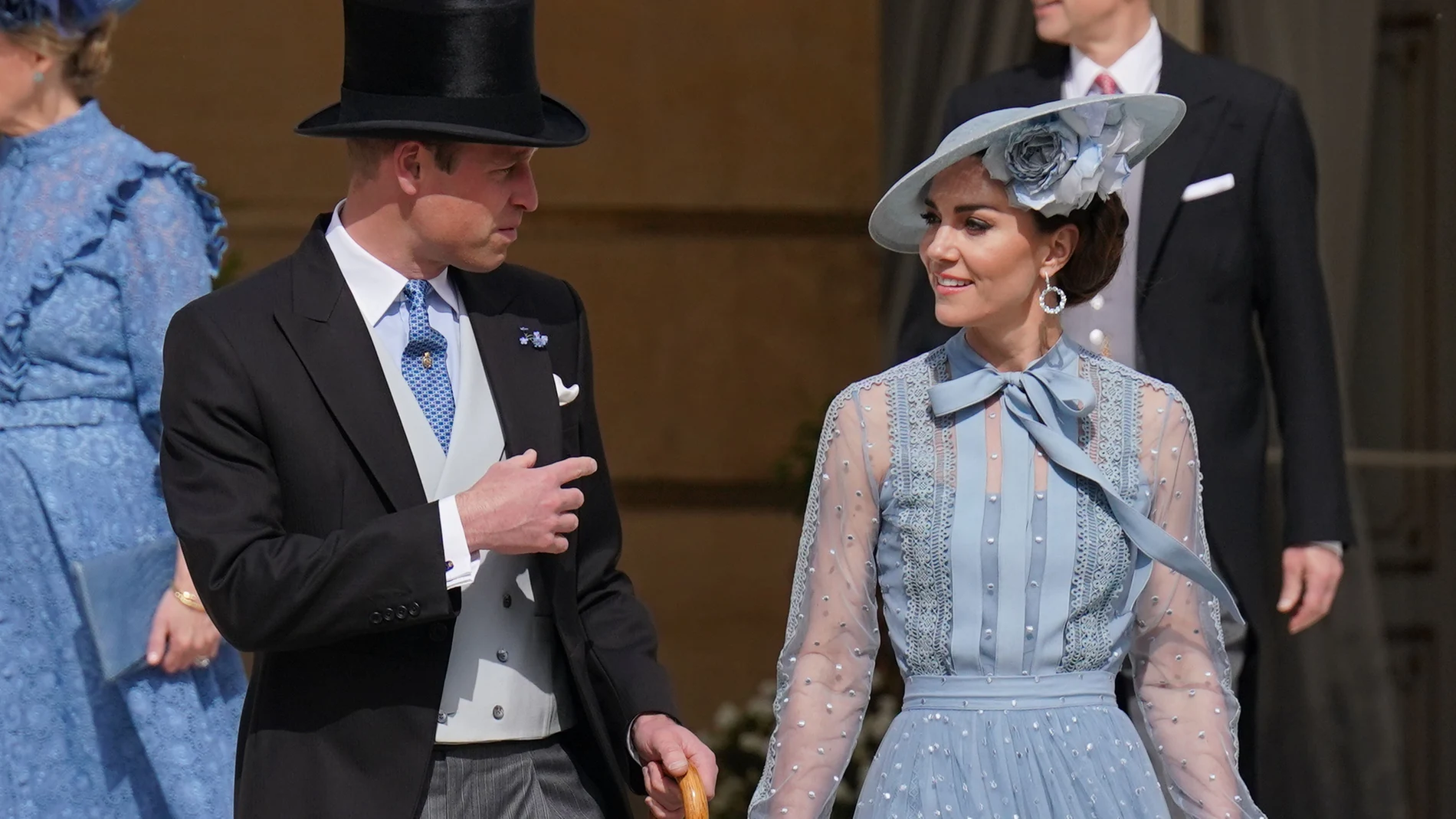William, Prince of Wales, speaks with his wife Kate, Princess of Wales, during a Garden Party at Buckingham Palace, in celebration of the coronation.