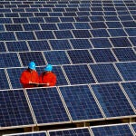 Workers check solar panels at a solar power station on a factory roof in Changxing, eastern China's Zhejiang province. 