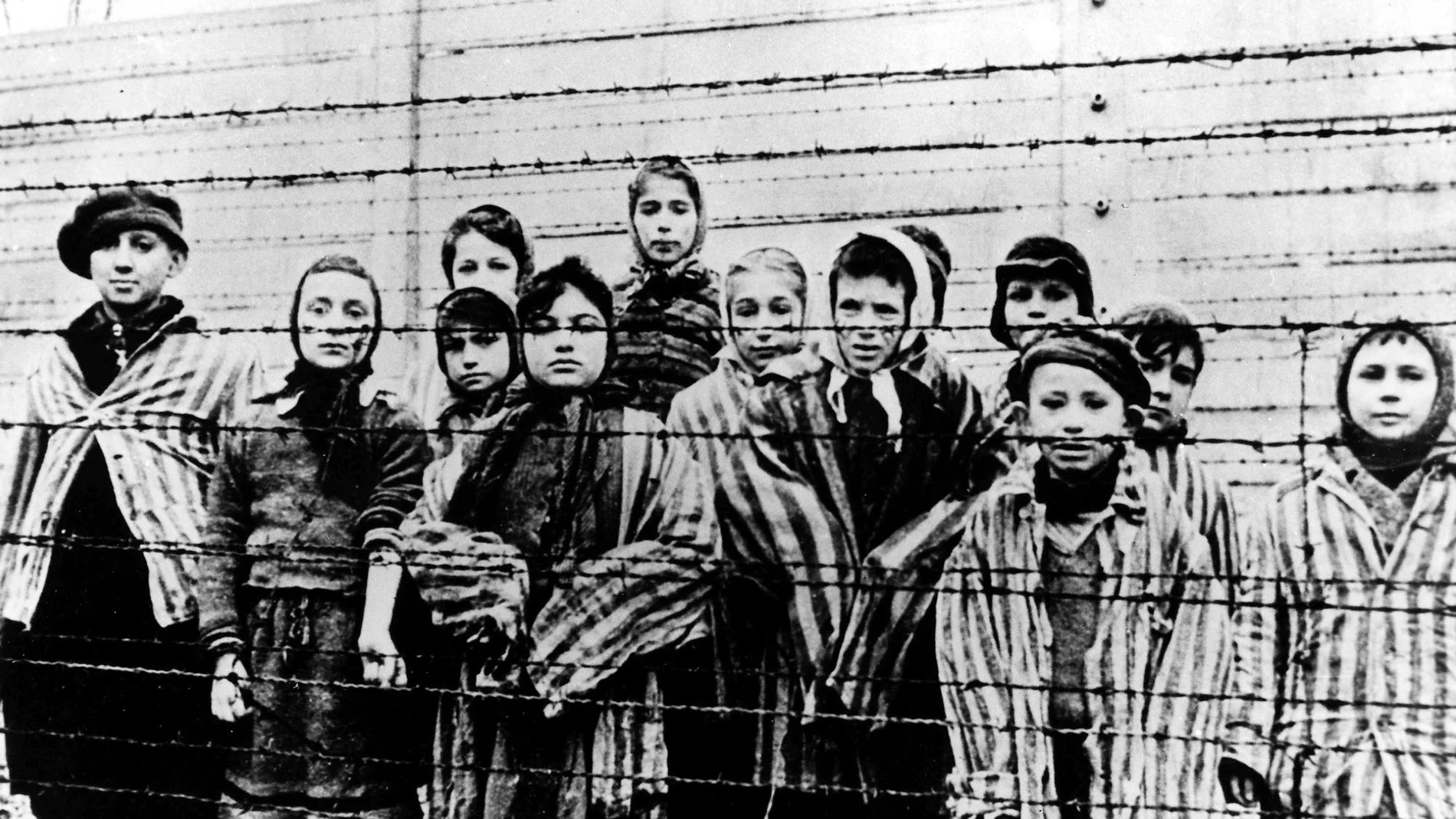 The file picture taken just after the liberation by the Soviet army in January, 1945, shows a group of children wearing concentration camp uniforms including Martha Weiss who was ten years-old, 6th from right, at the time behind barbed wire fencing in the Oswiecim (Auschwitz) Nazi concentration camp.