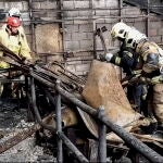 Russian rescuers clear the rubble and extinguish fires at Moscow's Crocus City Hall