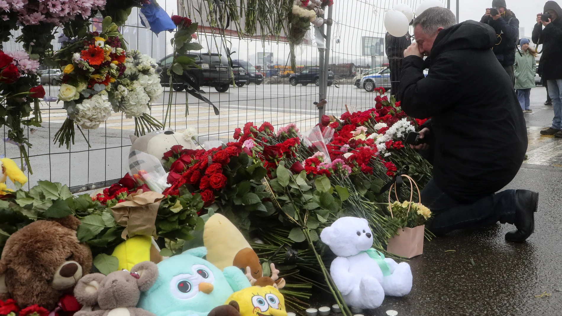 People mourn and bring flowers at the Crocus City Hall concert venue following a terrorist attack in Krasnogorsk, outside Moscow, Russia, 23 March 2024.