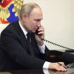 Russian President Vladimir Putin speaks over the phone during his address, the day after a terror attack on the Crocus City Hall in Krasnogorsk.