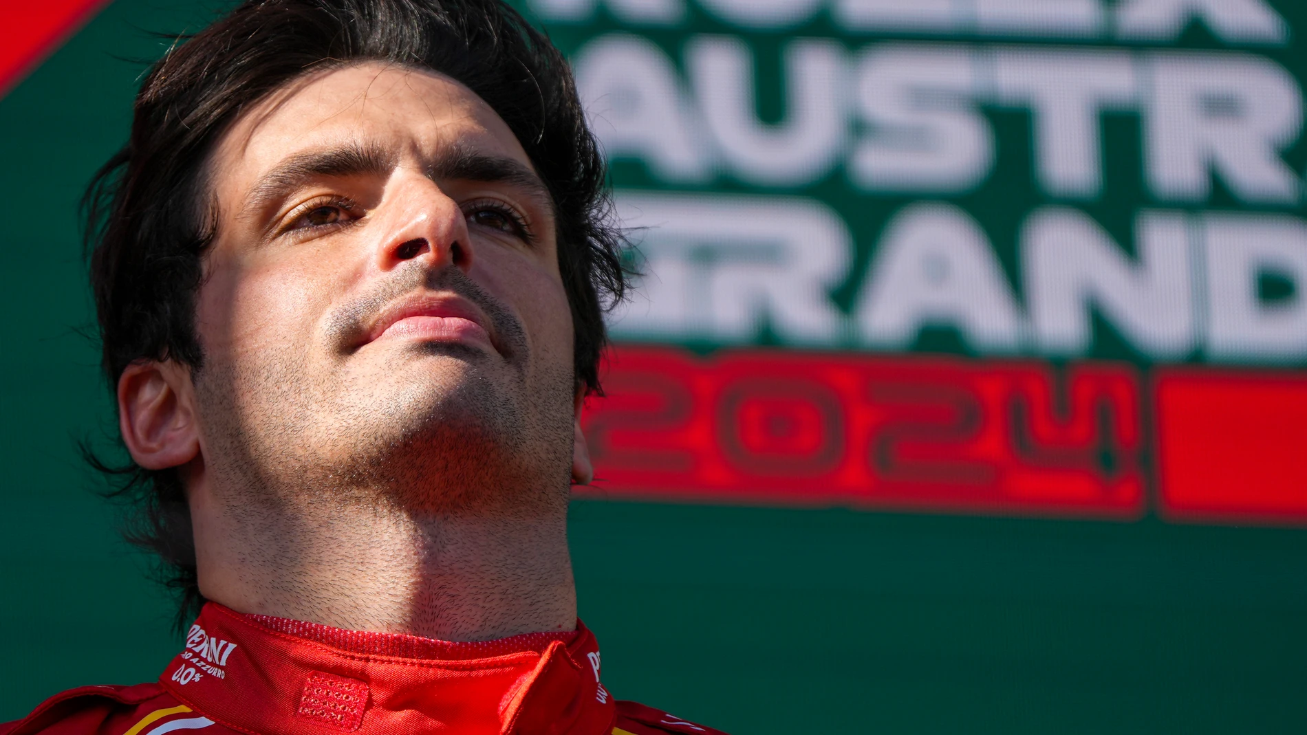 Ferrari driver Carlos Sainz of Spain reacts on the podium after winning the Australian Formula One Grand Prix at Albert Park, in Melbourne, Australia, Sunday, March 24, 2024. (AP Photo/Asanka Brendon Ratnayake)