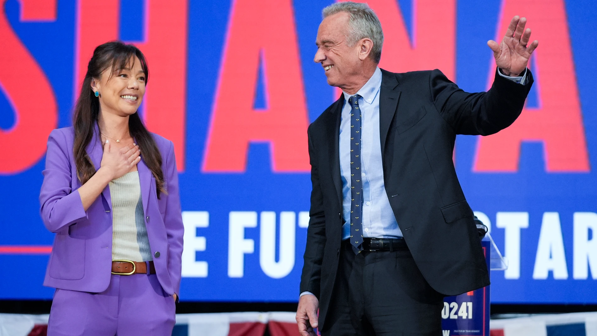 Presidential candidate Robert F. Kennedy Jr. right, waves on stage with Nicole Shanahan, after announcing her as his running mate, during a campaign event, Tuesday, March 26, 2024, in Oakland, Calif. (AP Photo/Eric Risberg)