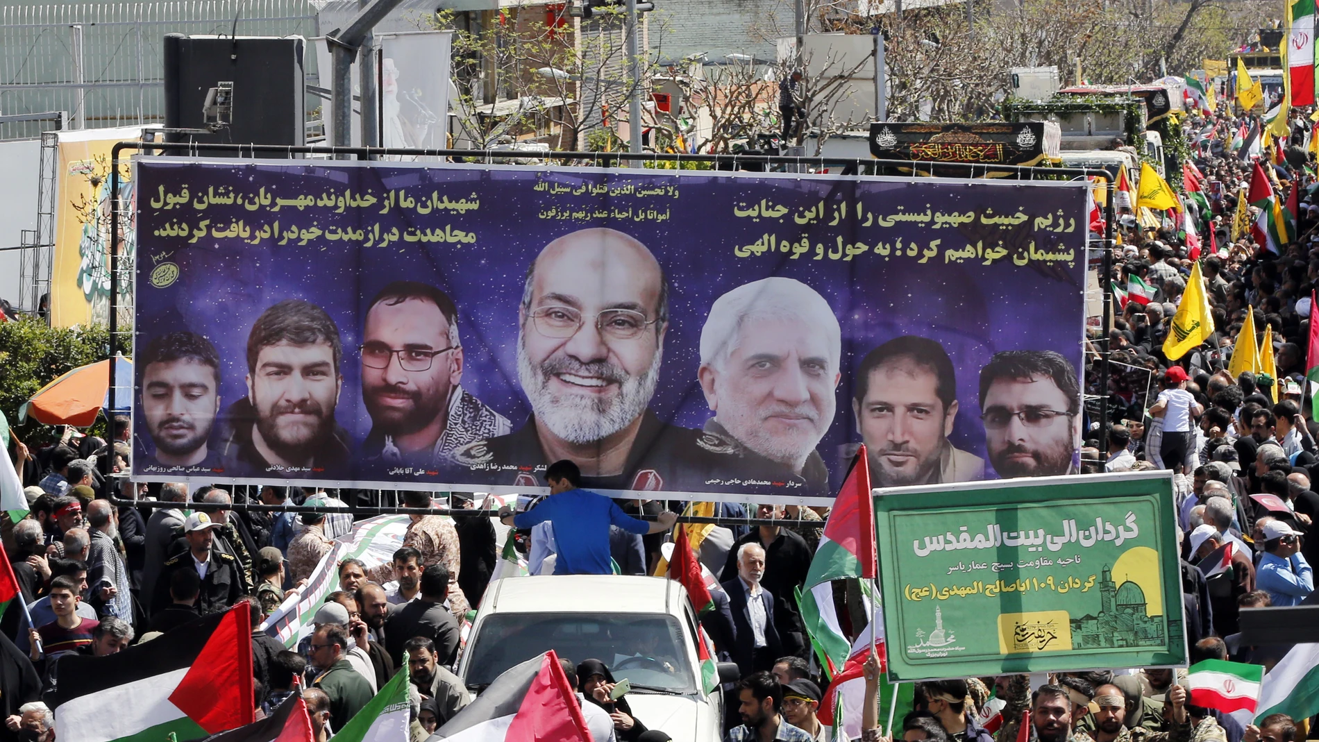 Tehran (Iran (islamic Republic Of)), 05/04/2024.- A large banner showing seven members of the Islamic Revolutionary Guard Corps (IRGC) who were killed in an airstrike in Syria, is paraded during their funeral ceremony in Tehran, Iran, 05 April 2024. According to Iranian state media quoting the Islamic Revolutionary Guard Corps, at least seven IRGC military advisors, including generals Mohammad Reza Zahedi and Mohammad Hadi Haj Rahimi, were killed in an airstrike on the Iranian consulate build...