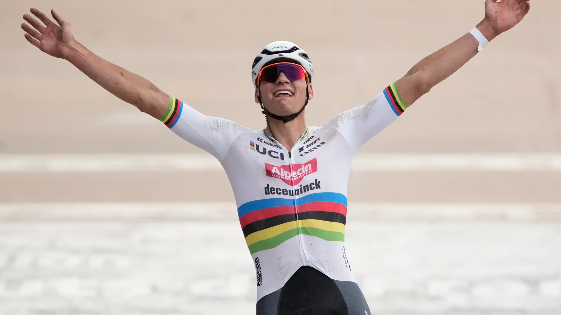 Netherland's Mathieu van der Poel celebrates as he crosses the finish line to win the men's Paris Roubaix, a 260 kilometer (162 miles) one-day-race, at the velodrome in Roubaix, northern France, Sunday, April. 7, 2024. (AP Photo/Christophe Ena)