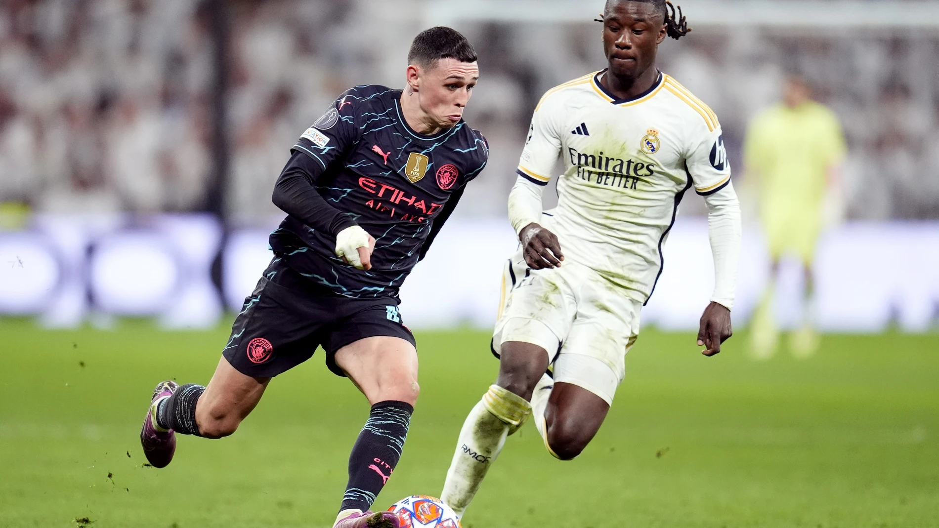 09 April 2024, Spain, Madrid: Manchester City's Phil Foden (L) and Real Madrid's Eduardo Camavinga battle for the ball during the UEFA Champions League quarter-final first leg soccer match between Real Madrid and Manchester City at the Santiago Bernabeu Stadium. Photo: Nick Potts/PA Wire/dpa 09/04/2024 ONLY FOR USE IN SPAIN