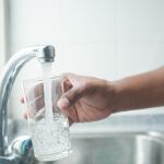 Imagen de una persona llenando un vaso con agua del grifo