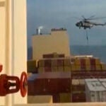 This image grab taken from a UGC video posted on social media on April 13, 2024 shows Iran's Revolutionary Guards rappelling down onto a container ship named, MSC Aries, near the Strait of Hormuz. - Iran's Revolutionary Guards on Saturday seized a container ship "related to the Zionist regime (Israel) in the Gulf," 