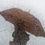 Una persona camina bajo la lluvia
