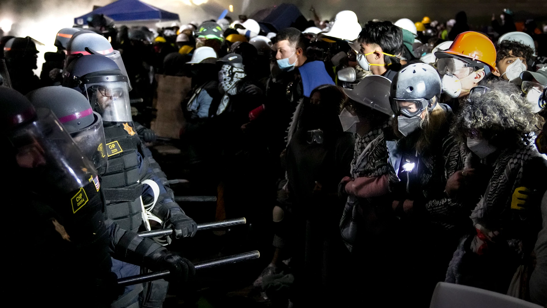 Los Angeles (United States), 02/05/2024.- Police officers confront demonstrators gathered at the ongoing encampment of pro-Palestinian protesters on the campus of University of California Los Angeles (UCLA) in Los Angeles, California, USA, 02 May 2024. Nationwide protests have sprung up across the country on school campuses, many calling for institutions to divest investments in Israel and in support of a ceasefire in the Gaza conflict. (Protestas) EFE/EPA/ALLISON DINNER