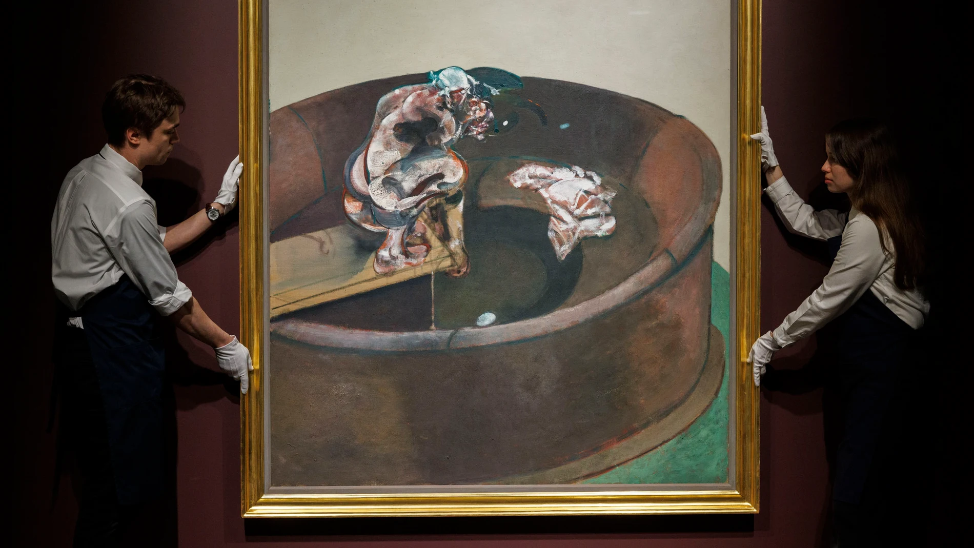 New York (United States), 03/05/2024.- Art handlers pose for the press with Francis Bacon's 'Portrait George Dyer Crouching,' the first single-panel portrait of Dyer to appear at auction in a decade, on display at Sotheby's auction house in New York, New York, USA, 03 May 2024. Their New York Marquee Evening Sales will take place on 13 and 15 May 2024. (Nueva York) EFE/EPA/SARAH YENESEL