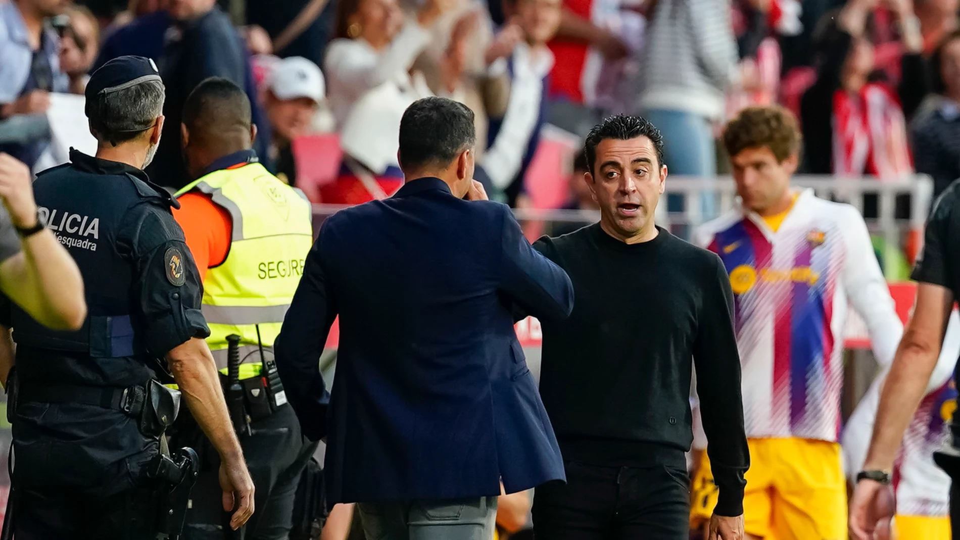 Girona, 04/05/2024. Los técnicos del FC Barcelona, Xavi Hernández (d) y del Girona, Michel, se saludan a la finalización del encuentro correspondiente a la jornada 34 de Primera División que Girona y FC Barcelona han disputado hoy sábado en el estadio municipal de Montilivi, en la localidad gerundense. EFE/David Borrat.