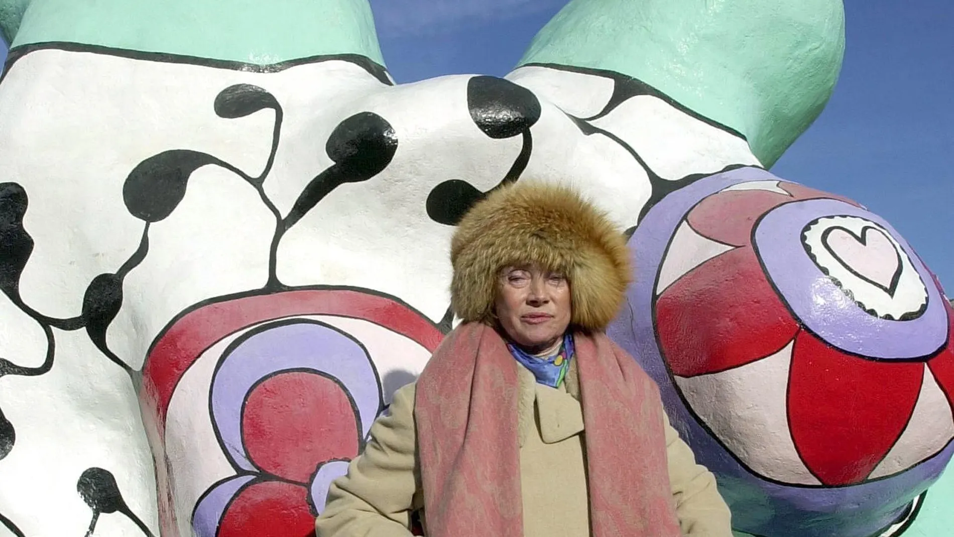 French-born artist Niki de Saint Phalle posing in front of her `Nana`sculptures on display in Hanover