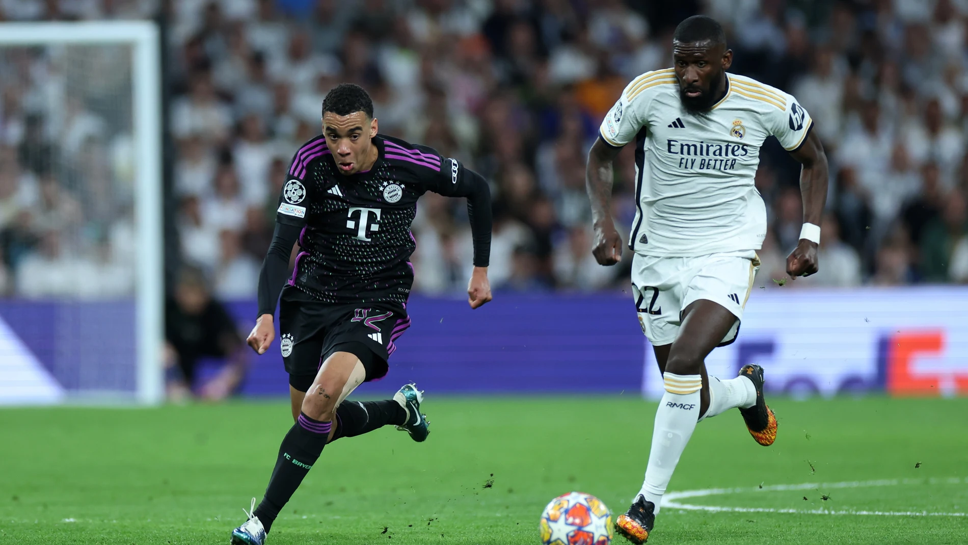 08 May 2024, Spain, Madrid: Bayern Munich's Jamal Musiala (L) gets away from Real Madrid's Antonio Rudiger during the UEFA Champions League semi-final, second leg match between Real Madrid and Bayern Munich at the Santiago Bernabeu. Photo: Isabel Infantes/PA Wire/dpa 08/05/2024 ONLY FOR USE IN SPAIN