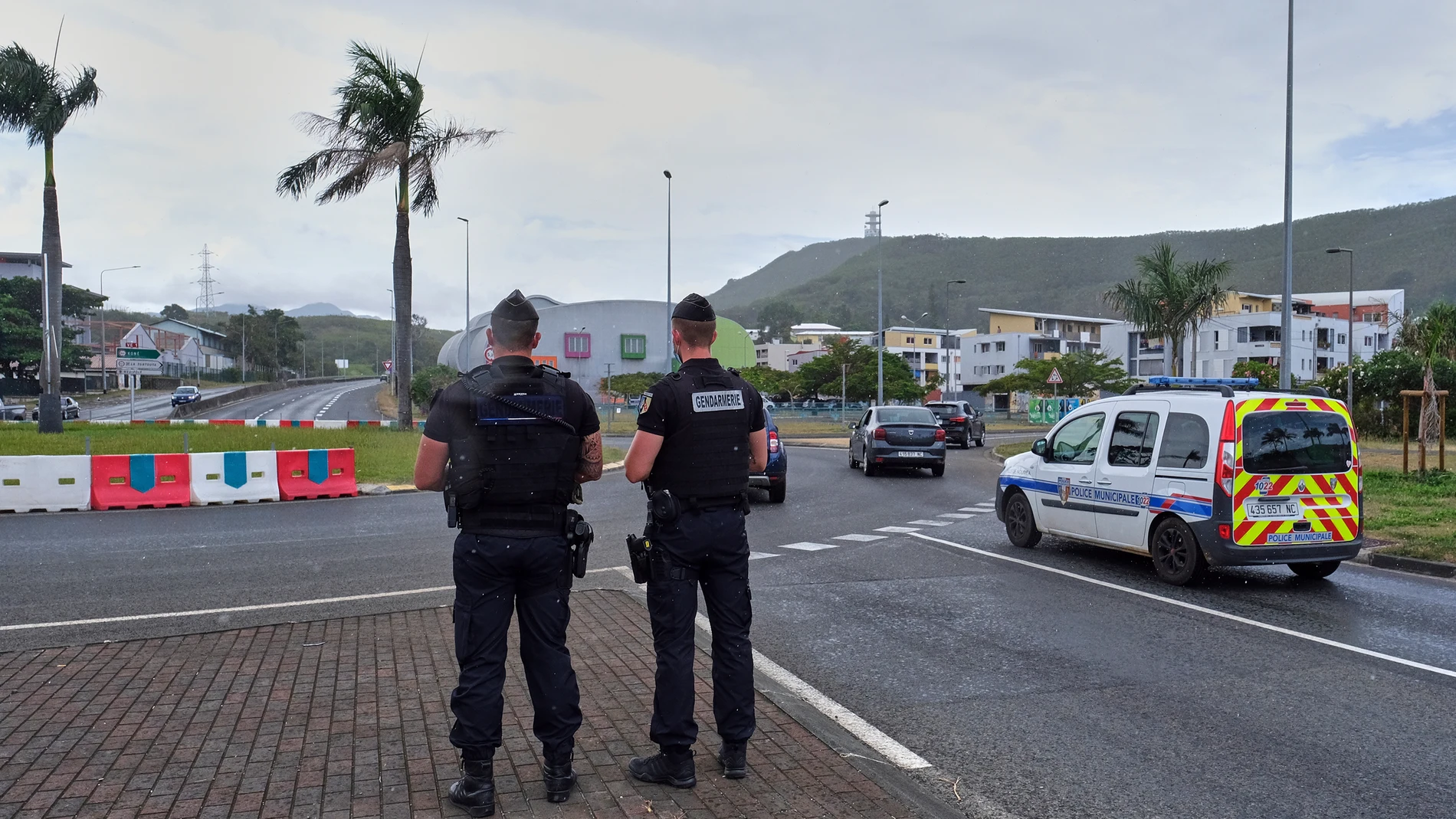 FILE - French gendarme patrol at a roundabout in Noumea, New Caledonia, Sunday Dec.12, 2021. At least two people were killed and three were seriously injured overnight in the French Pacific territory of New Caledonia, French officials there said Wednesday, May 15, 2024, as President Emmanuel Macron convened a meeting of top ministers to discuss the spiraling violence. (AP Photo/Clotilde Richalet, File)