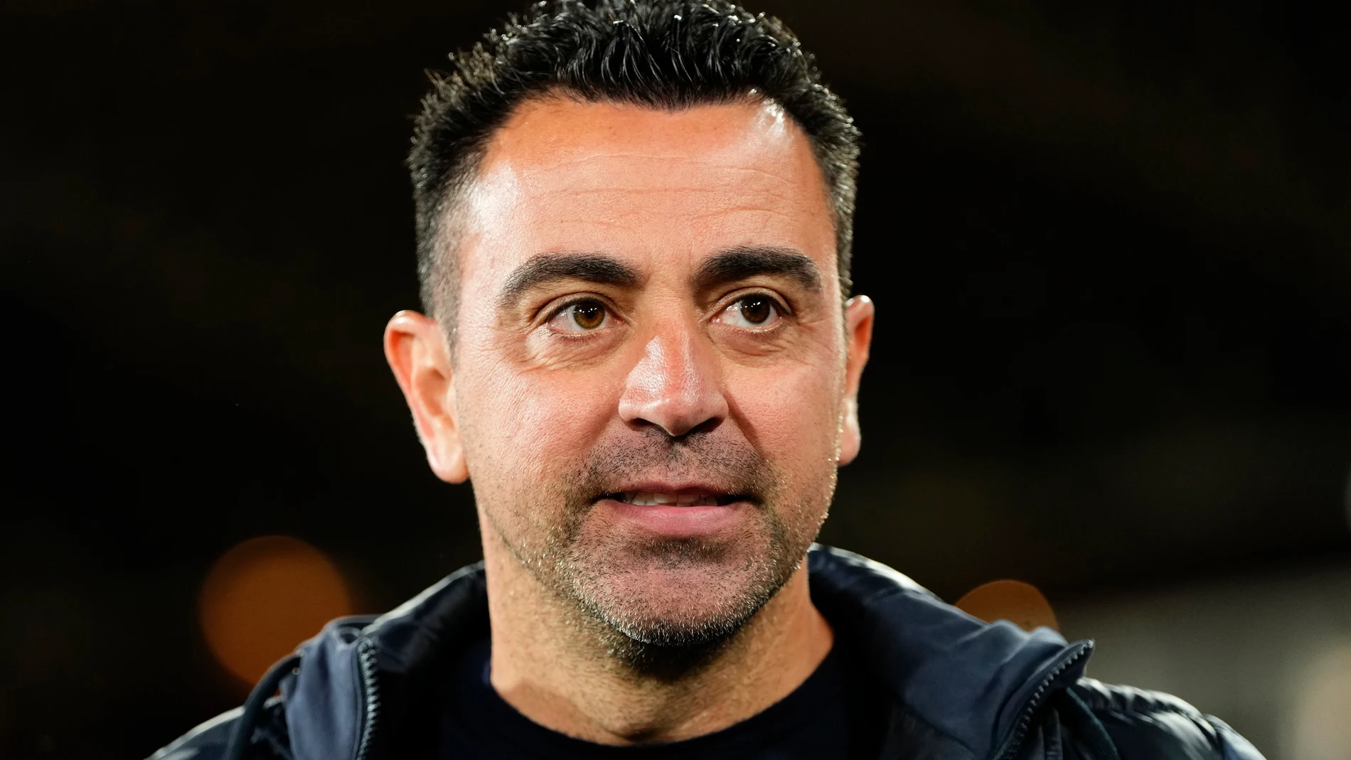 Barcelona's head coach Xavi Hernandez walks to his seat before a Spanish La Liga soccer match between Almeria and Barcelona at the Power Horse stadium in Almeria, Spain, Thursday, May 16, 2024. (AP Photo/Jose Breton)