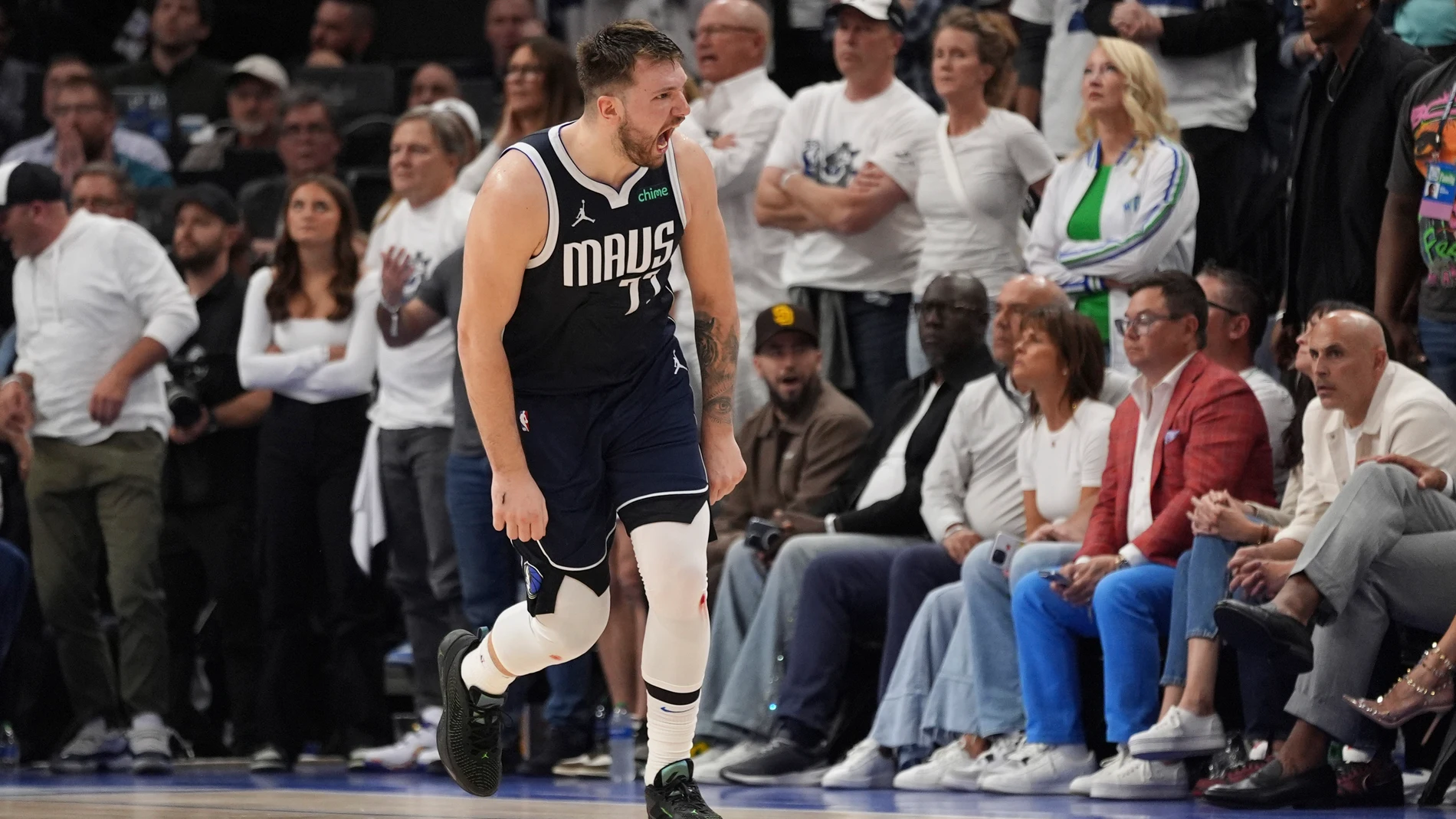 Dallas Mavericks guard Luka Doncic (77) celebrates a score against the Minnesota Timberwolves during the second half in Game 1 of the NBA basketball Western Conference finals, Wednesday, May 22, 2024, in Minneapolis. (AP Photo/Abbie Parr)