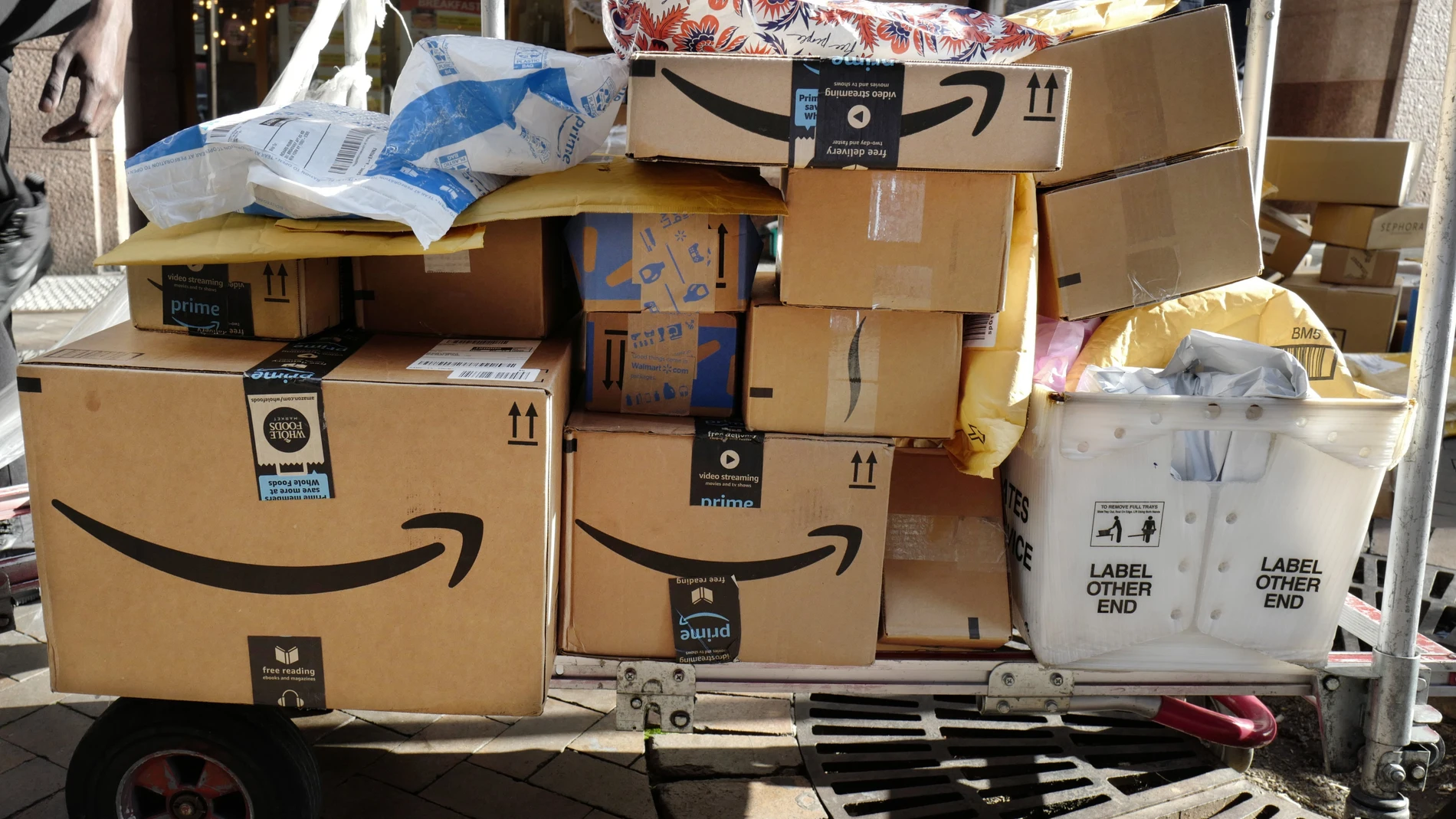 FILE - In this Oct. 10, 2018, file photo Amazon Prime boxes are loaded on a cart for delivery in New York. The nation’s major shipping companies are in the best shape to get holiday shoppers’ packages delivered on time since the start of the pandemic, suggesting a return to normalcy. (AP Photo/Mark Lennihan, File)