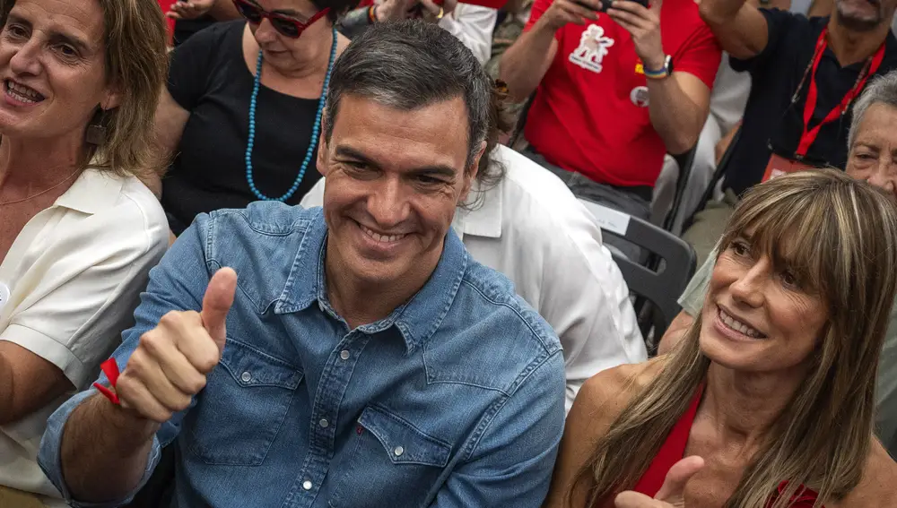 Spain's Prime Minister Pedro Sanchez next to his wife Begona Gomez, gives a thumb up during a campaign closing meeting in Madrid, Spain.