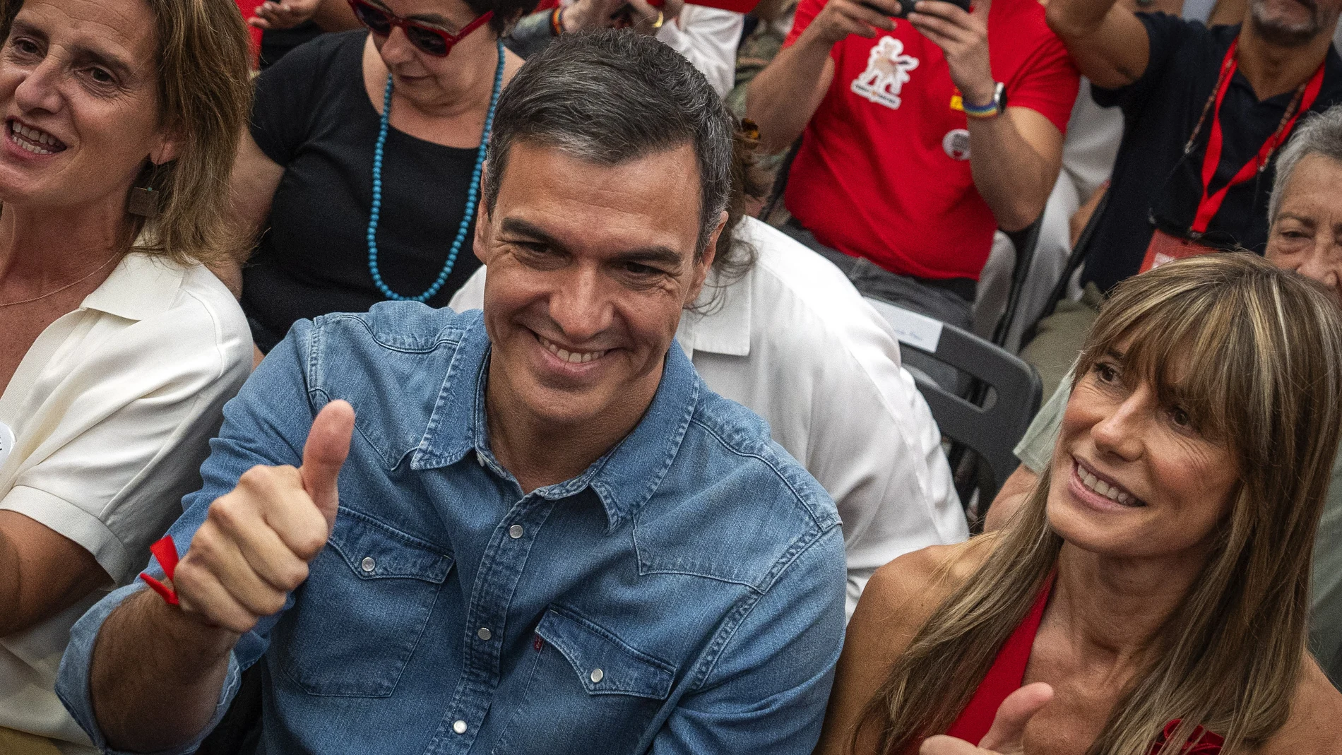 Spain's Prime Minister Pedro Sanchez next to his wife Begona Gomez, gives a thumb up during a campaign closing meeting in Madrid, Spain.