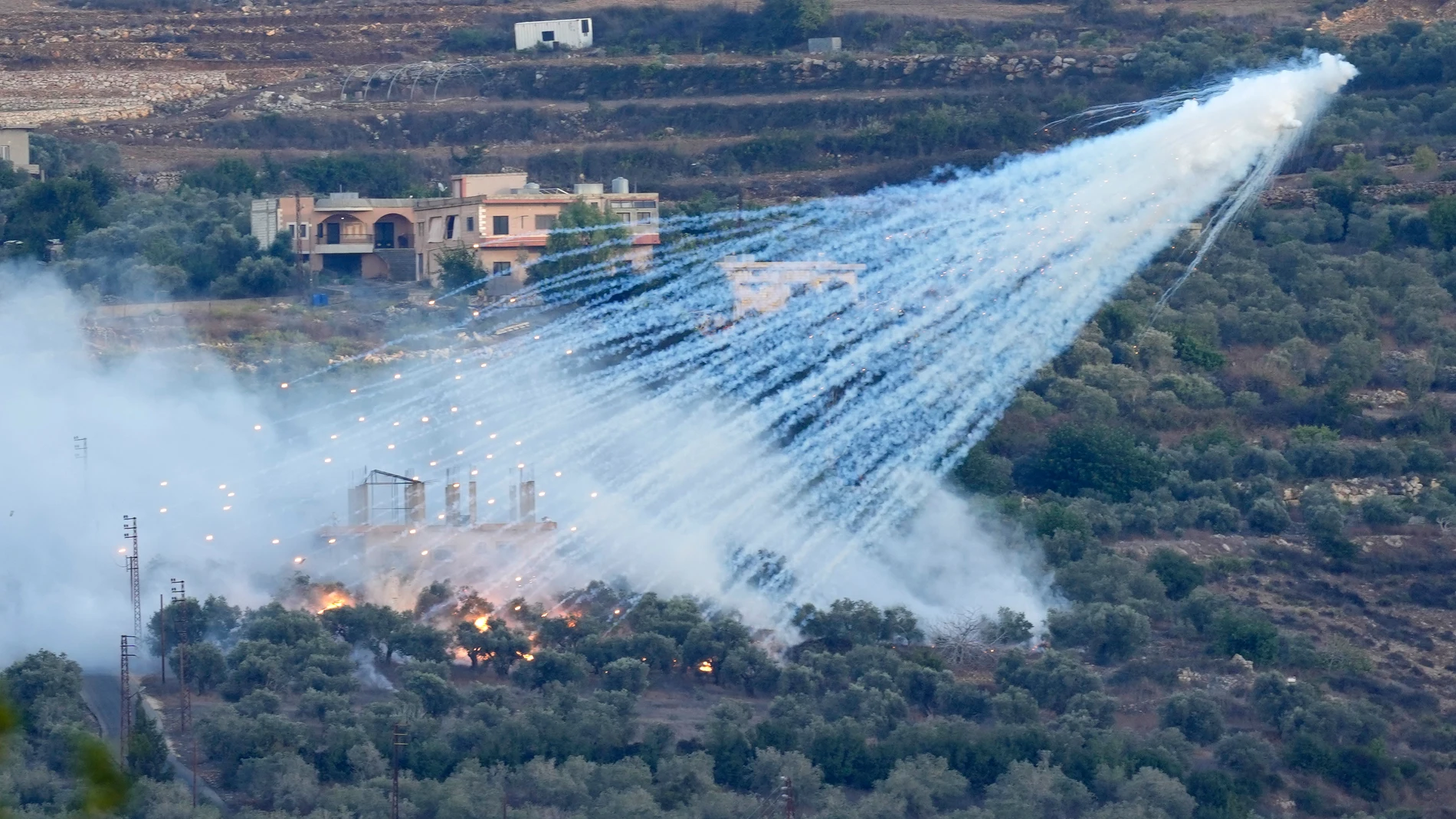 FILE - A shell that appears to be white phosphorus from Israeli artillery explodes over a house in al-Bustan, a Lebanese village along the border with Israel, on Oct. 15, 2023. Israel's use of the controversial white phosphorus incendiary shells in conflict-hit southern Lebanon has harmed civilians and should be investigated as a possible crime under international law, global human rights group Human Rights Watch said Wednesday, June 5, 2024. (AP Photo/Hussein Malla, File)