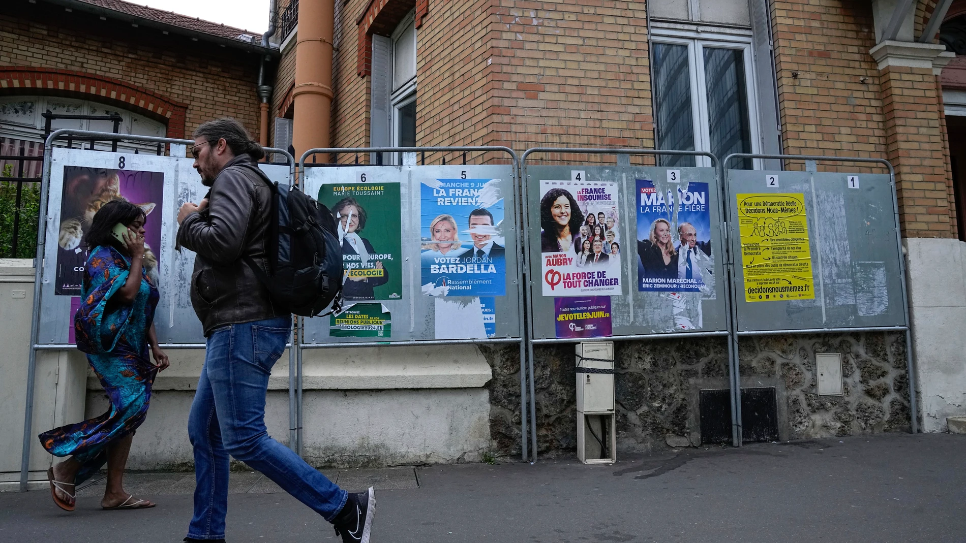 People walk past a row of campaign posters for the upcoming European election in Courbevoie, west of Paris, Thursday, June 6, 2024. The European Election will take place on June 9. (AP Photo/Michel Euler)