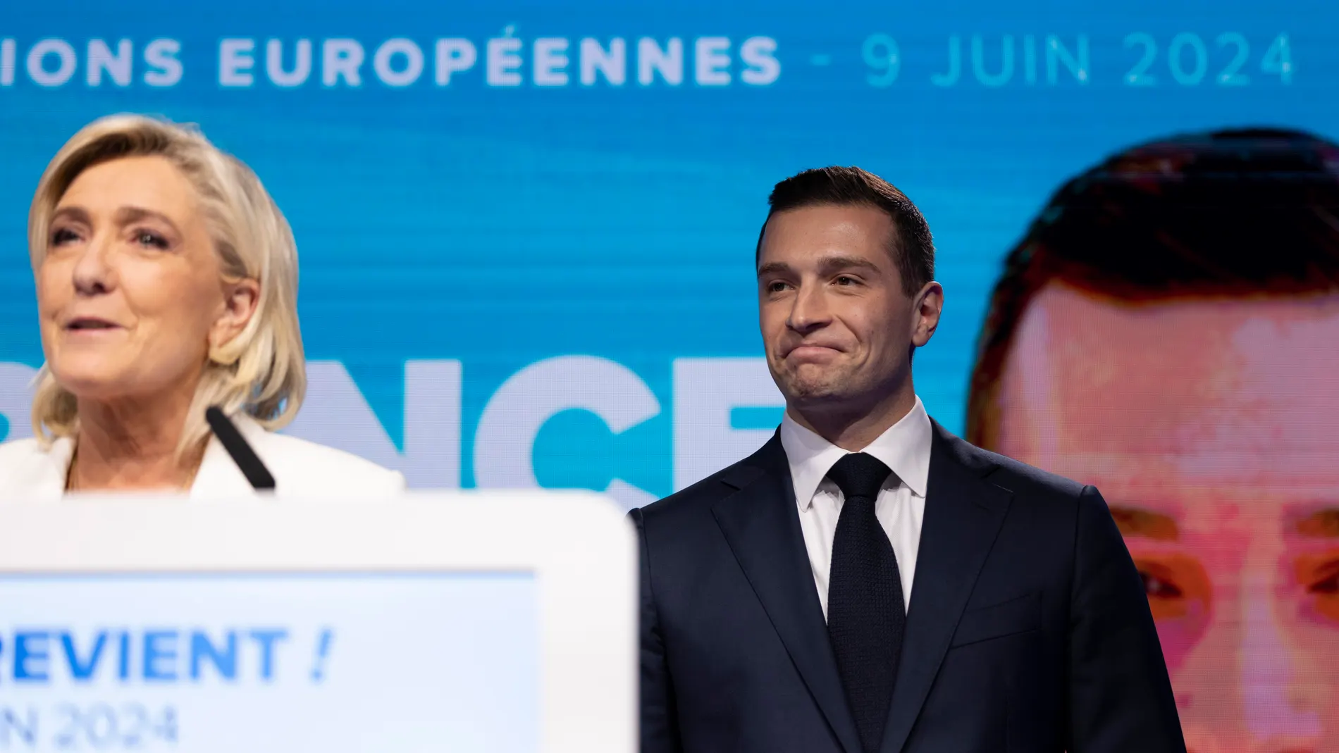 Paris (France), 09/06/2024.- National Rally leader Jordan Bardella (R) reacts as parliamentary party leader Marine Le Pen (L) delivers a speech at the electoral party of the French right-wing party National Rally (Rassemblement National or RN) in Paris, France, 09 June 2024, after the first results of the European elections. The list of the Rassemblement National, led by party chief Jordan Bardella, is given winner in France according to first estimations after polls. (Elecciones, Francia, Jo...