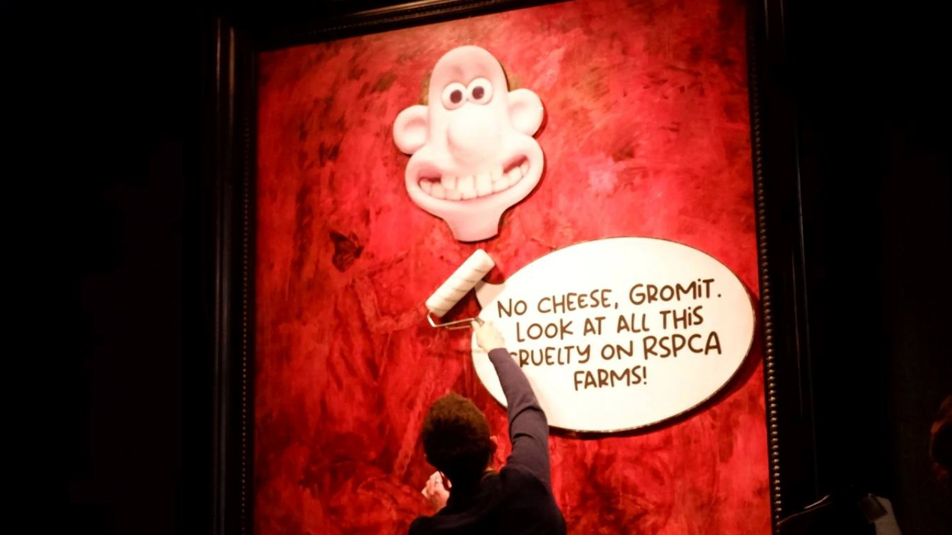 This photo released by Animal Rising shows an activist pasting a picture of a character called Wallace, from the “Wallace and Gromit” comedy series, over a portrait of Britain's King Charles III at the Philip Mould Gallery in London, Tuesday June 11, 2024. Animal rights activists pasted a cartoon image over a portrait of King Charles III on Tuesday at a London art gallery, the latest in a series of incidents at U.K. museums as campaigners use vandalism to publicize their causes. (Animal Risin...