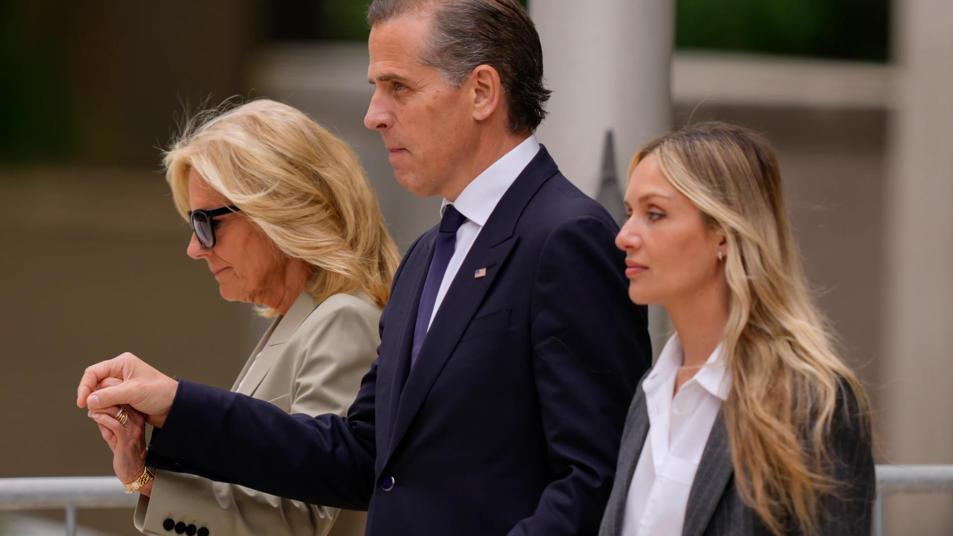Hunter Biden, center, President Joe Biden's son, accompanied by his mother, first lady Jill Biden, left, and his wife, Melissa Cohen Biden, right, walking out of federal court after hearing the verdict, Tuesday, June 11, 2024, in Wilmington, Del. Hunter Biden has been convicted of all 3 felony charges in the federal gun trial. (AP Photo/Matt Rourke)