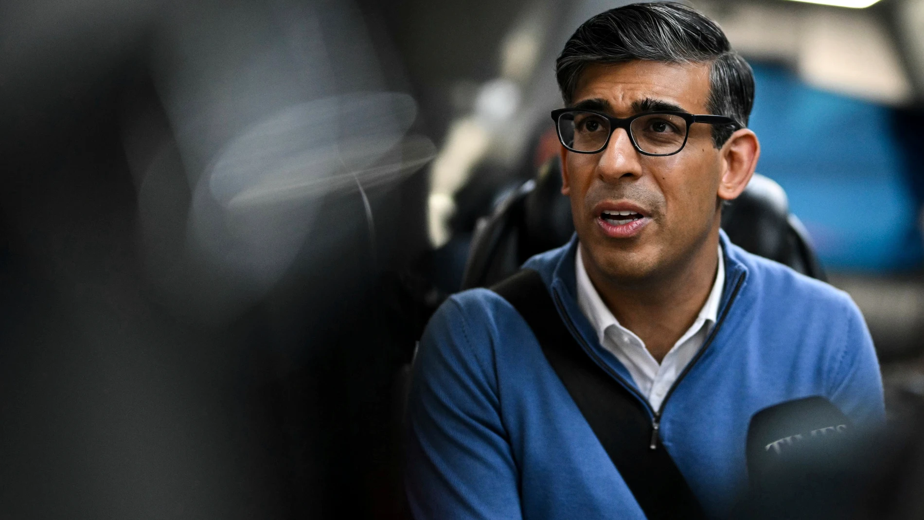 Britain's Prime Minister and Conservative Party leader, Rishi Sunak speaks with journalists aboard the party campaign bus on its way to Grimsby, England, Wednesday June 12, 2024, ahead of the UK General Election on July 4. (Oli Scarff/Pool via AP)