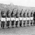 The Italian soccer team perform the fascist salute in Colombes Stadium, Paris, before the start of the World Cup final soccer match against Hungary on June 19, 1938. Earlier in the tournament that was taking place amid the drumbeat of war, the team caused consternation by wearing black shirts in a match. 