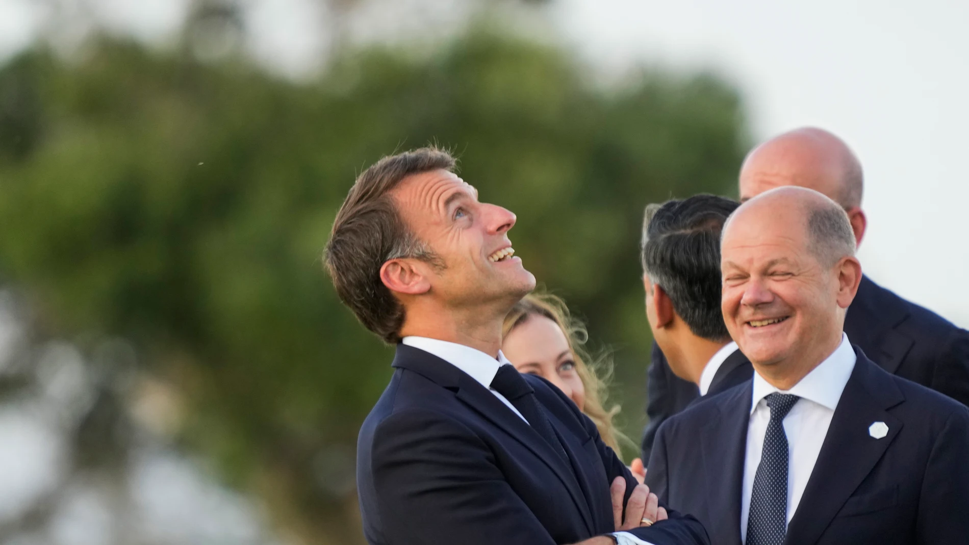 French President Emmanuel Macron, left, talks to German Chancellor Olaf Scholz as they watch a skydiving demo during the G7 world leaders summit at Borgo Egnazia, Italy, Thursday, June 13, 2024. (AP Photo/Luca Bruno)