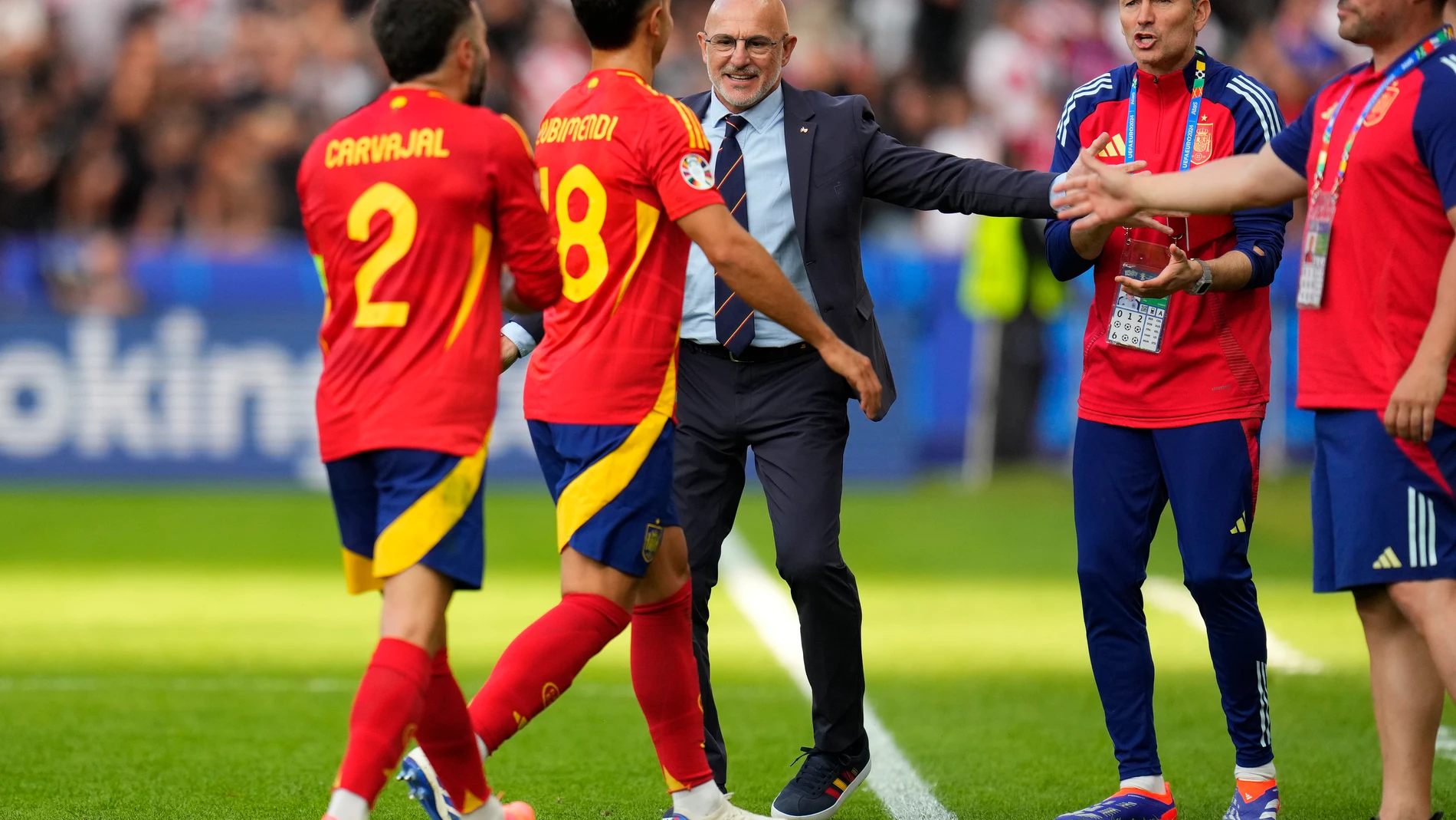 Spain's head coach Luis de la Fuente, center, celebrates with teammates at the end of a Group B match between Spain and Croatia at the Euro 2024 soccer tournament in Berlin, Germany, Saturday, June 15, 2024. Spain defeated Croatia 3-0. (AP Photo/Manu Fernandez)