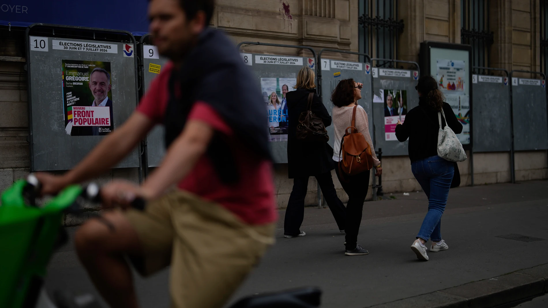 People walk past campaign boards for the upcoming parliamentary elections in Paris, Saturday June 22, 2024. (AP Photo/Thibault Camus)