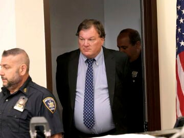 Rex Heuermann, center, charged in the Gilgo Beach serial killings on Long Island, enters the courtrrom for a hearing at Suffolk County Court in Riverhead, N.Y.