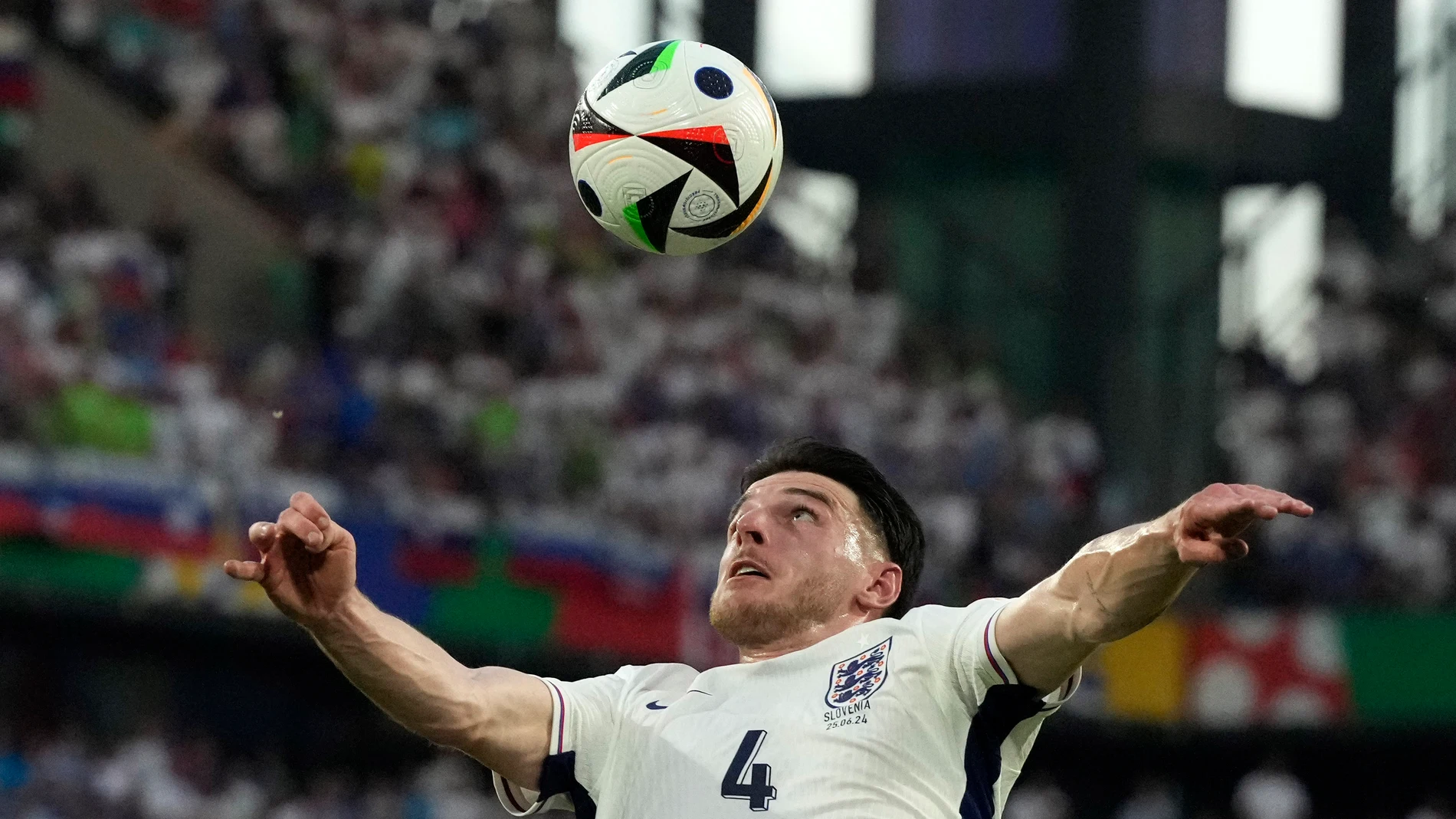 England's Declan Rice, top, heads the ball as Slovenia's Adam Gnezda Cerin watches during a Group C match between the England and Slovenia at the Euro 2024 soccer tournament in Cologne, Germany, Tuesday, June 25, 2024. (AP Photo/Frank Augstein)