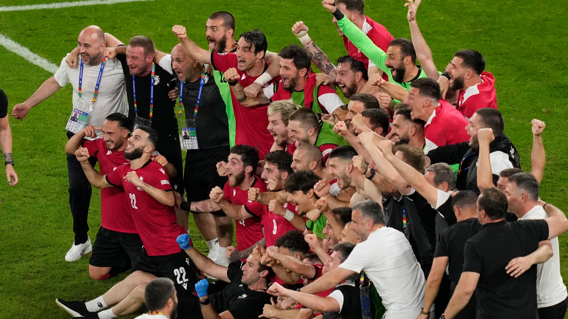Georgia's team and staff members celebrate at the end of a Group F match between Georgia and Portugal at the Euro 2024 soccer tournament in Gelsenkirchen, Germany, Wednesday, June 26, 2024. (AP Photo/Andreea Alexandru)