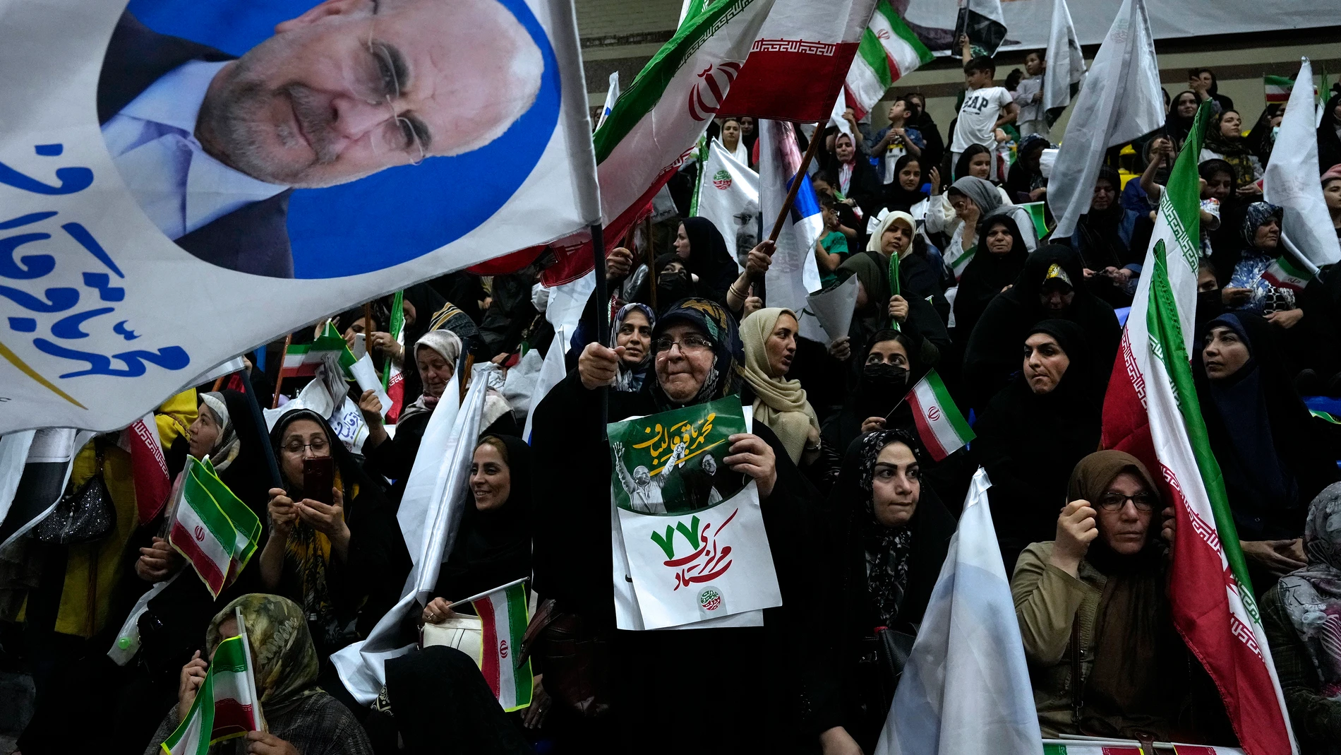Supporters of Iran's parliament speaker Mohammad Bagher Qalibaf, the most prominent hard-line candidate for the presidential election, attend his campaign gathering in Tehran, Iran, Wednesday, June 26, 2024. (AP Photo/Vahid Salemi)