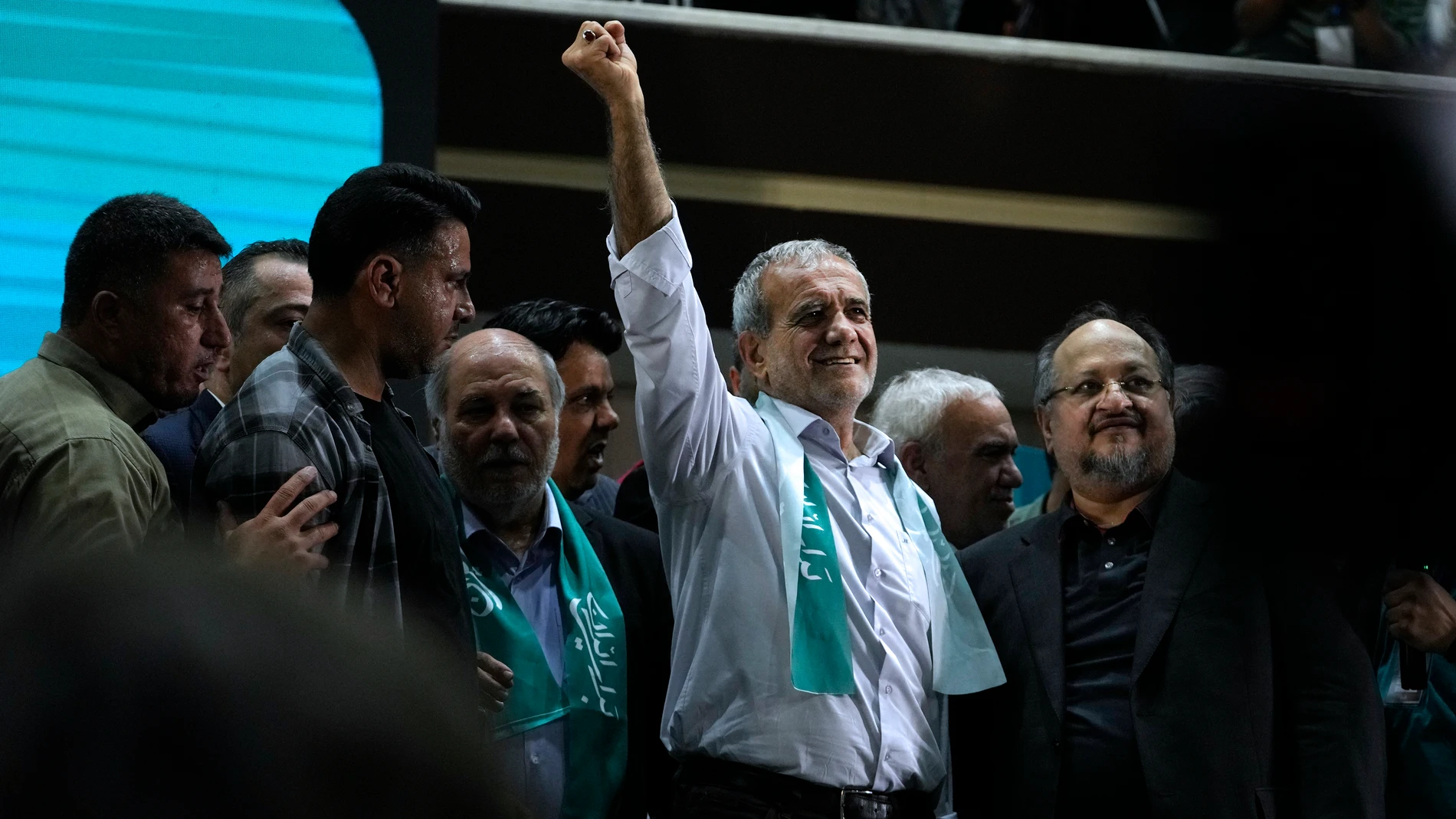 Reformist candidate for Iran's presidential election Masoud Pezeshkian clenches his fist in a campaign meeting in Tehran, Iran, Sunday, June 23, 2024. (AP Photo/Vahid Salemi)