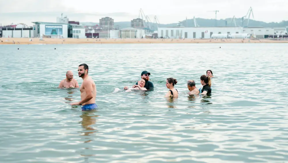 Varios residentes bañándose en Gijón