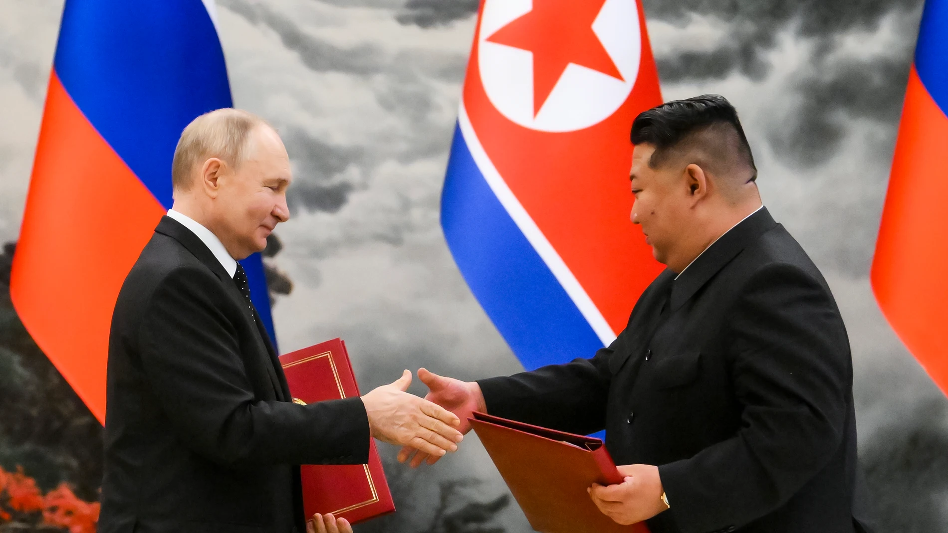 FILE - Russian President Vladimir Putin, left, and North Korean leader Kim Jong Un exchange documents during a ceremony for their new partnership in Pyongyang, North Korea, on Wednesday, June 19, 2024. The leaders signed a mutual defense pact, and Putin held the door open for arms supplies to the North. (Kristina Kormilitsyna, Sputnik, Kremlin Pool Photo via AP, File)