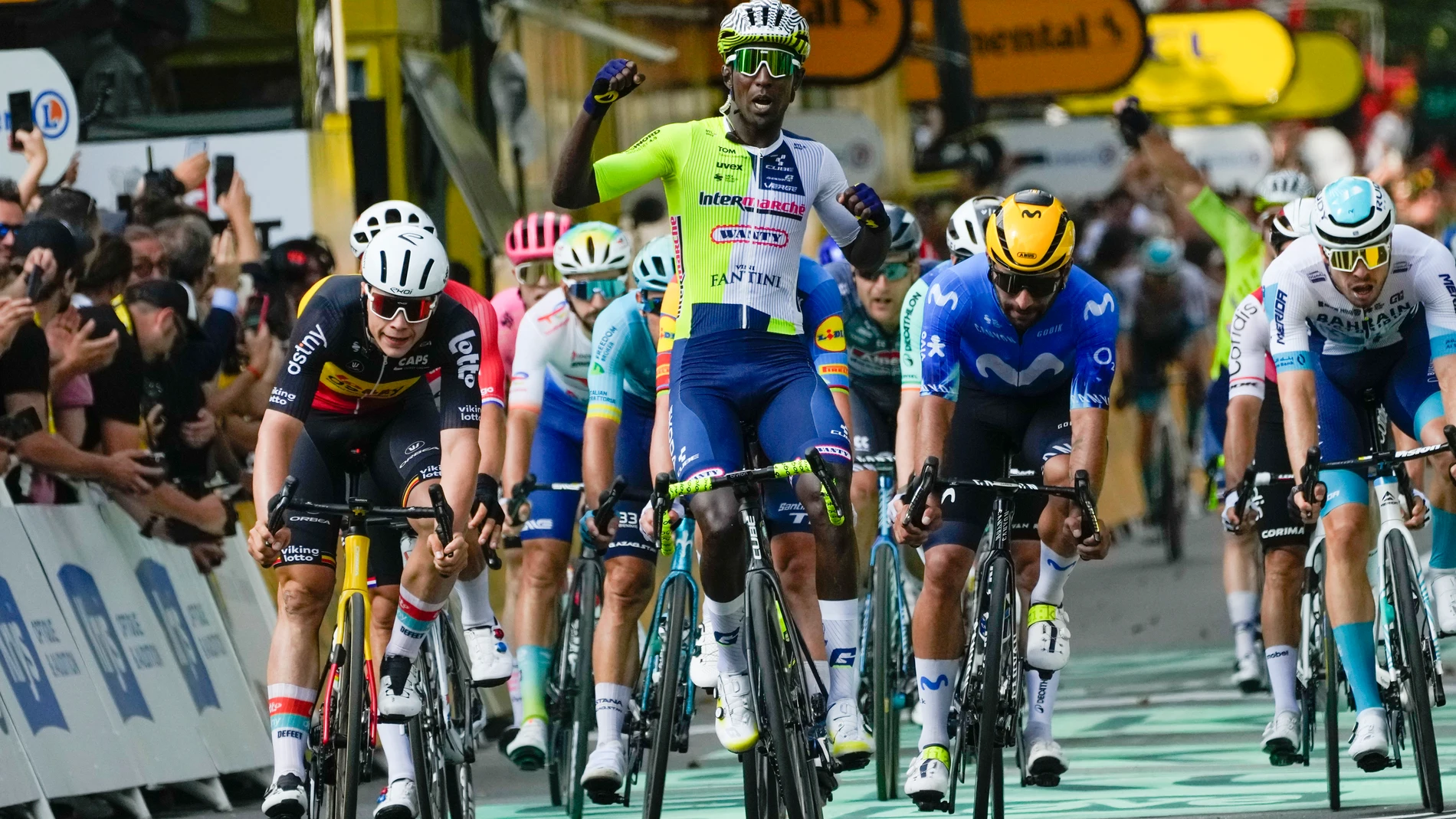 Eritrea's Biniam Girmay celebrates winning ahead of Belgium's Arnaud de Lie, left, and Colombia's Fernado Gavira, center right, during the third stage of the Tour de France cycling race over 230.8 kilometers (143.4 miles) with start in Piacenza and finish in Turin, Italy, Monday, July 1, 2024. (AP Photo/Jerome Delay)