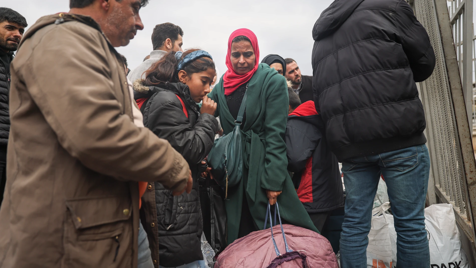 FILE - Syrians wait to cross into Syria from Turkey at the Cilvegozu border gate, near the town of Antakya, southeastern Turkey, Tuesday, Feb. 21, 2023. Turkish President Recep Tayyip Erdogan accused opposition parties of stoking xenophobia and racism on Monday July 1, 2024, a day after residents in a neighborhood in central Turkey set Syrian-owned shops on fire. (AP Photo/Unal Cam, File)