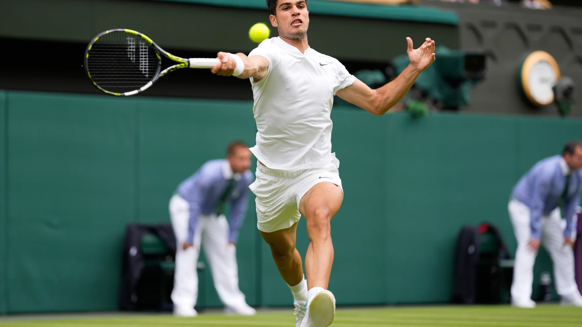 Carlos Alcaraz of Spain plays a forehand return to Mark Lajal of Estonia during their first round match of the Wimbledon tennis championships in London, Monday, July 1, 2024. (AP Photo/Alberto Pezzali)