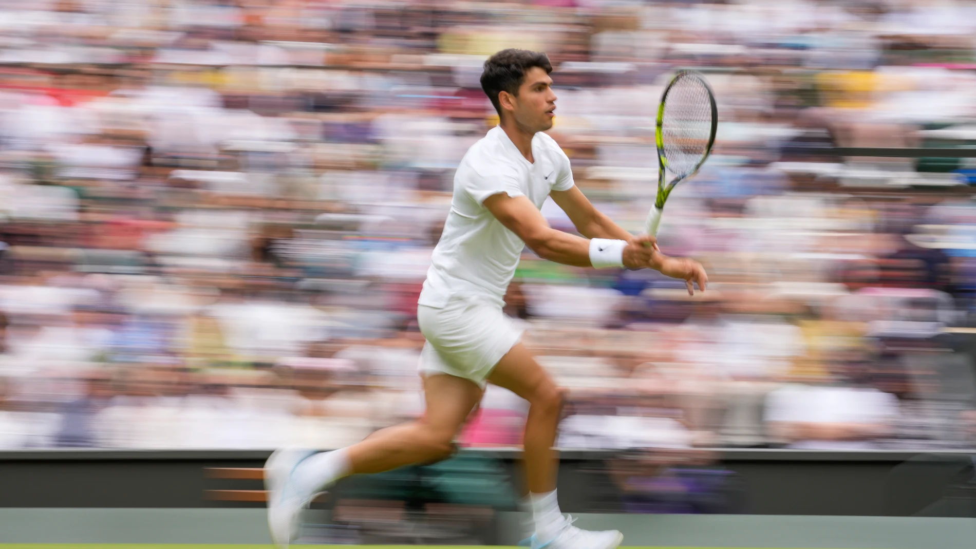 Carlos Alcaraz of Spain plays a forehand return to Mark Lajal of Estonia during their first round match of the Wimbledon tennis championships in London, Monday, July 1, 2024. (AP Photo/Alberto Pezzali)
