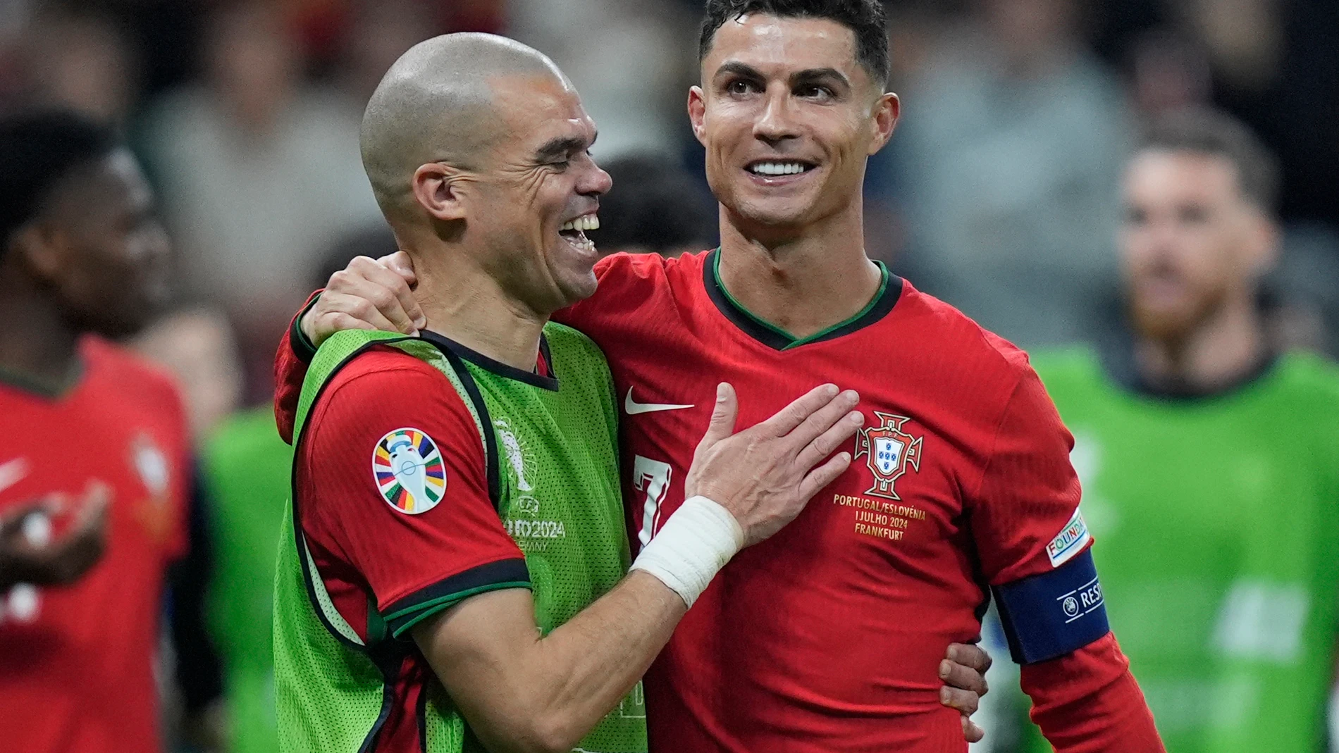 Portugal's Pepe, left, and Cristiano Ronaldo celebrate their win in penalties shootouts after a round of sixteen match between Portugal and Slovenia at the Euro 2024 soccer tournament in Frankfurt, Germany, Monday, July 1, 2024. (AP Photo/Matthias Schrader)