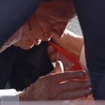 Secret Service tend to republican presidential candidate former President Donald Trump onstage at a rally on July 13, 2024 in Butler, Pennsylvania. Butler County district attorney Richard Goldinger said the shooter is dead after injuring former U.S. President Donald Trump, killing one audience member and injuring another in the shooting. Anna Moneymaker/Getty Images/AFP (Photo by Anna Moneymaker / GETTY IMAGES NORTH AMERICA / Getty Images via AFP)