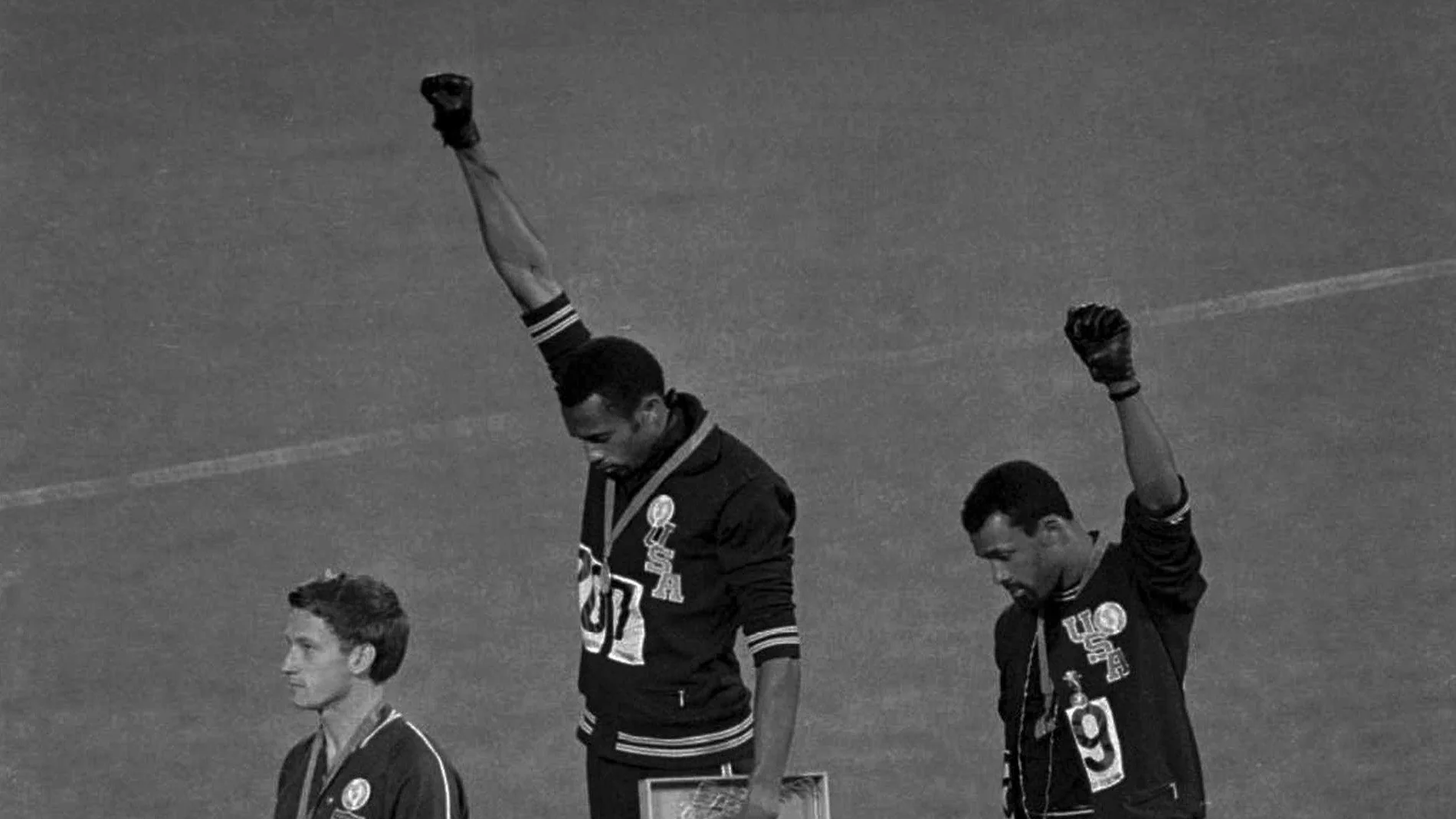Extending gloved hands skyward in racial protest, U.S. athletes Tommie Smith, center, and John Carlos, stare downward during the playing of the Star Spangled Banner after Smith received the gold and Carlos the bronze for the 200 meter run at the Olympics in Mexico City on Oct. 16, 1968. Australian silver medalist Peter Norman is at left. (AP Photo/files¡¡¡¡¡¡¡OJO FOTO DE COMPRA NO PUBLICAR SIN AUTORIZACION!!!!!!!!!!