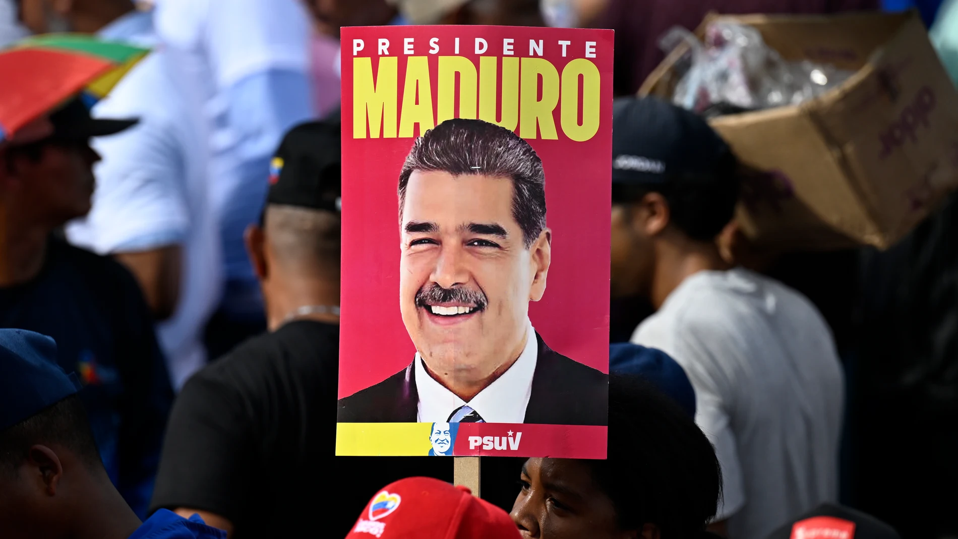 CARACAS, July 26, 2024 -- A supporter holds a poster of Venezuelan President Nicolas Maduro during Maduro's closing election campaign rally in Caracas, Venezuela, July 25, 2024. Over 20 million eligible voters are expected to cast their ballots on July 28 to elect a president in Venezuela. 25/07/2024